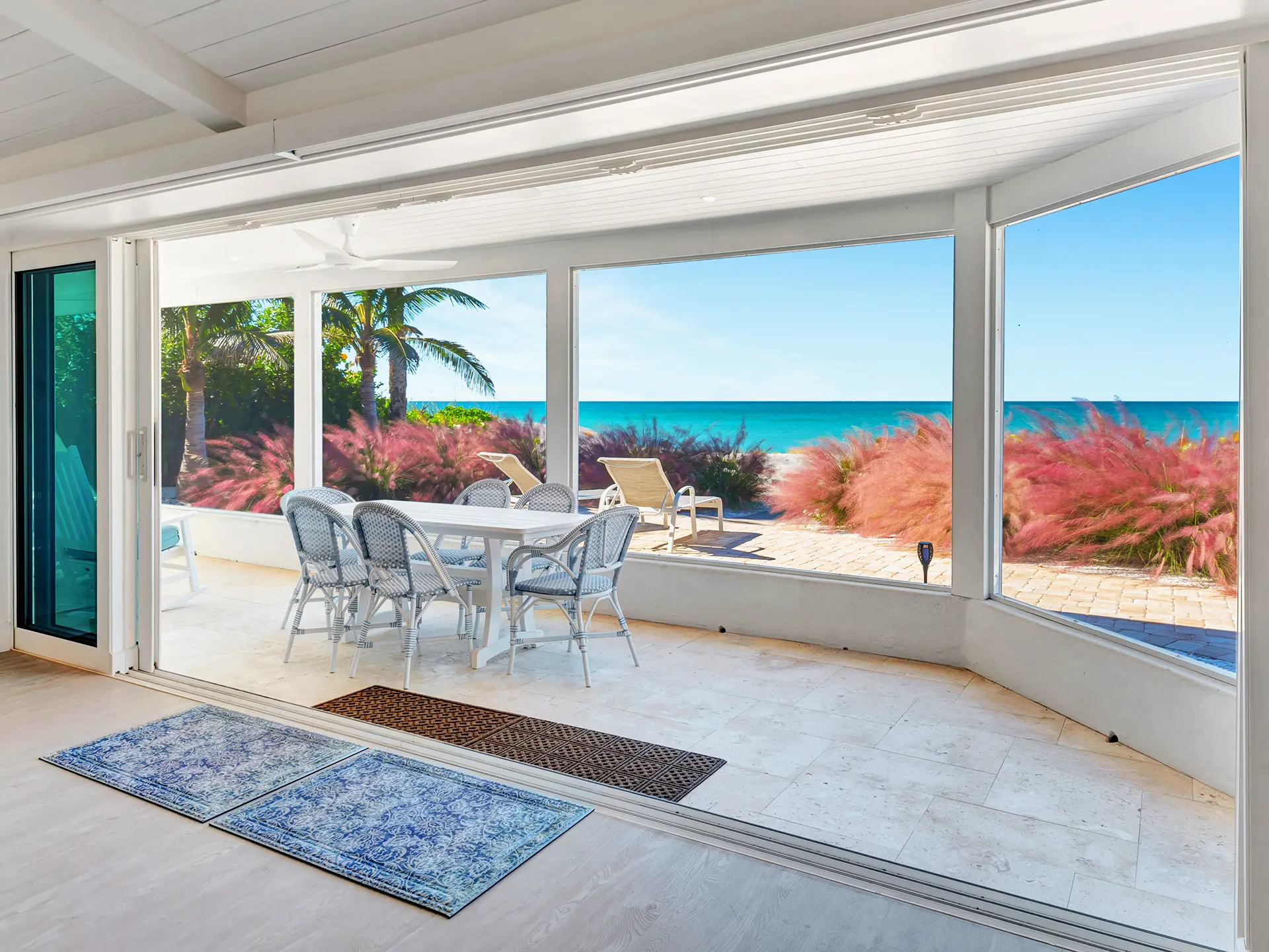 Outdoor Patio & Terrace of a luxury residential property in Englewood, Florida. This beautiful outdoor seating patio displaying custom stonework, ideal for lounging and sunset viewing on the Florida Gulf Coast, captured with professional real estate media standards.