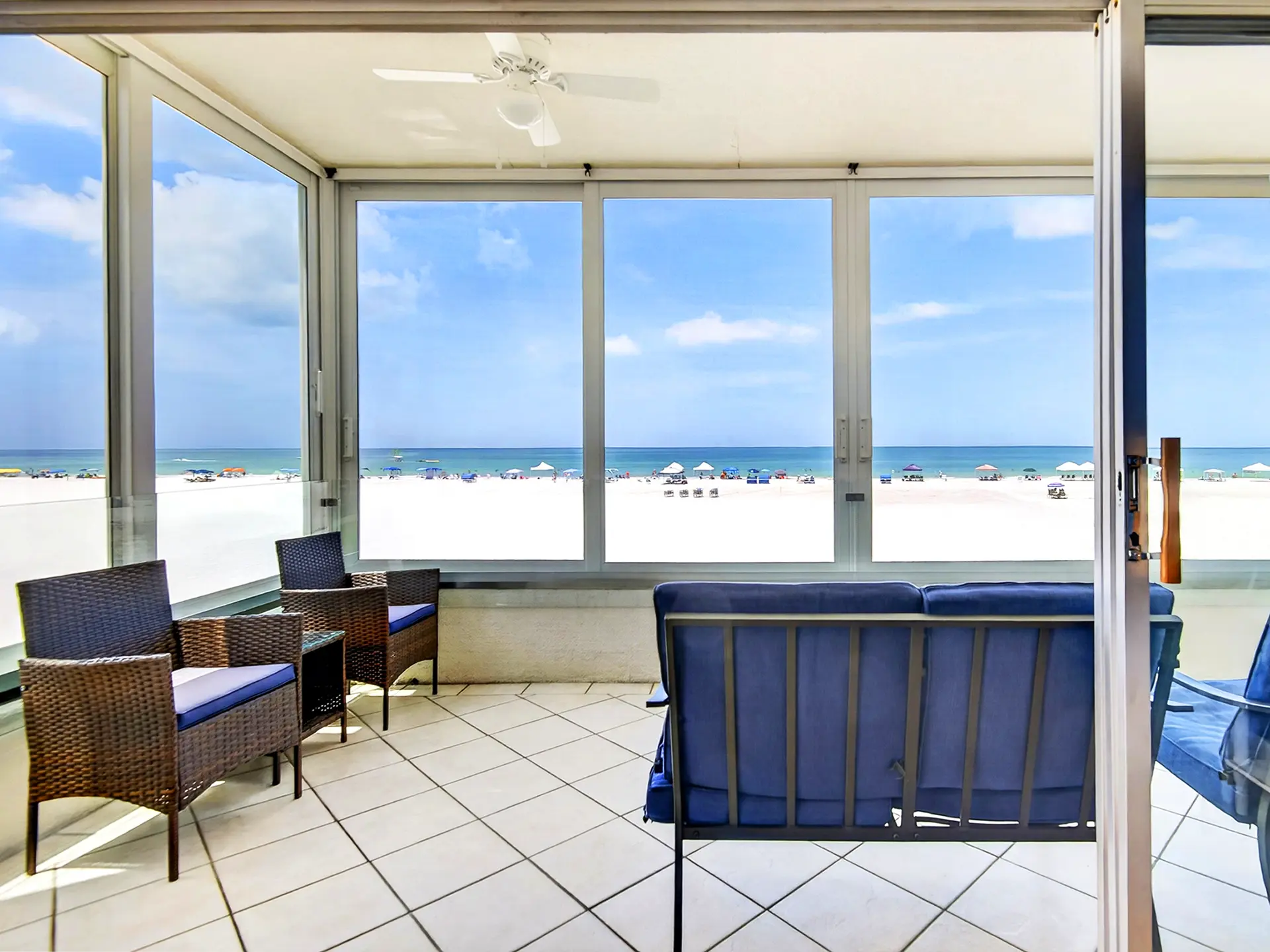 Outdoor Patio & Terrace of a luxury residential property in Siesta Key, Florida. This beautiful outdoor seating patio displaying custom stonework, ideal for lounging and sunset viewing on the Florida Gulf Coast, captured with professional real estate media standards.
